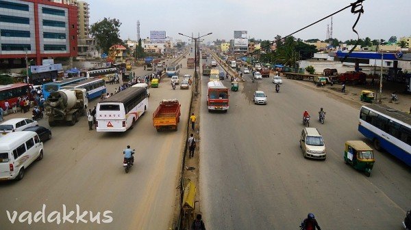 View of KR Puram Tin Factory bus stop from foot over bridge