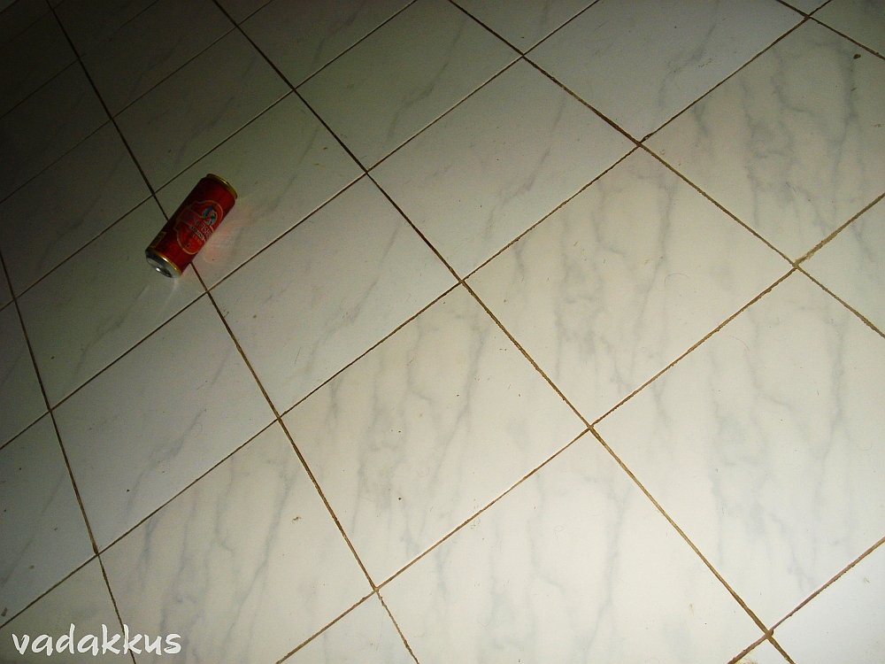 A Beer can among floor tiles, lost in the Time-Space Continuum