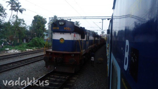 Frieght with WDG3A 13536 overtakes stopped Island Express at Kalamasserry in Kerala