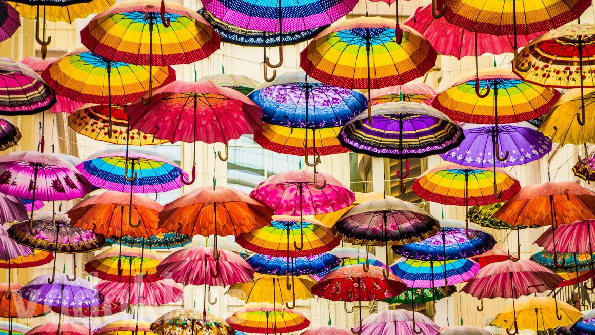 Colorful Umbrellas hanging, forming the "ceiling" at The Village at the Dubai Mall