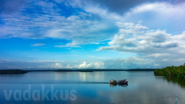 The Ashtamudi lake on a bright evening with the ferry service