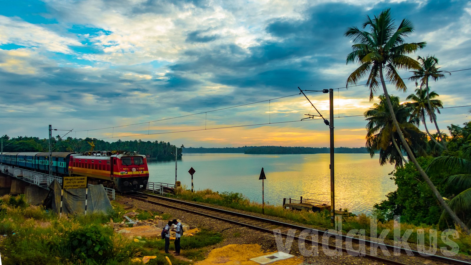 Train on the Perumon Ashtamudi railway bridge evening Kerala beautiful setting